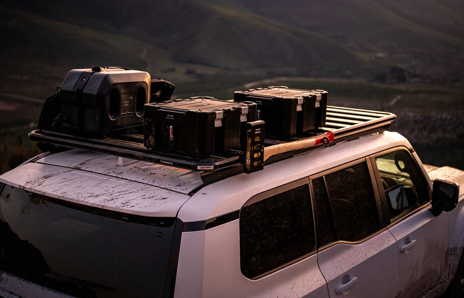 Slimline 3 roof rack loaded with cases and recovery gear on a Prado 250 at dusk