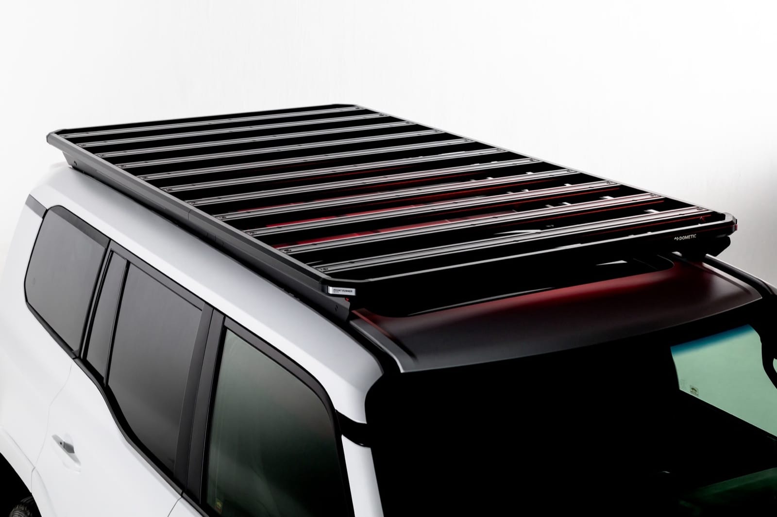 Studio shot of a Slimline 3 roof rack on a white Prado 250