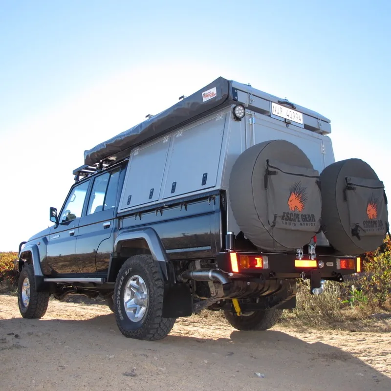 Black Land Cruiser 79 double cab with aluminium canopy, roof tent and twin spare wheels