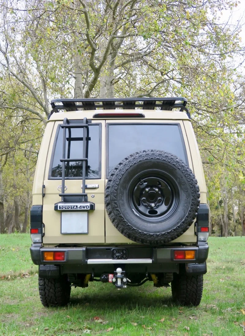 Rear of a Land Cruiser 78 Troopy with ladder, roof rack and spare wheel carrier