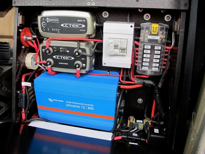Dual-battery and power panel in an overland build: chargers, inverter and fuse box
