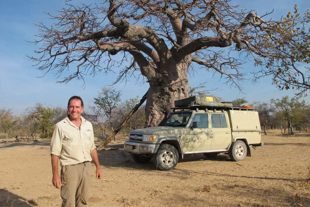 Paul Marsh with a Land Cruiser pick-up camper at a baobab