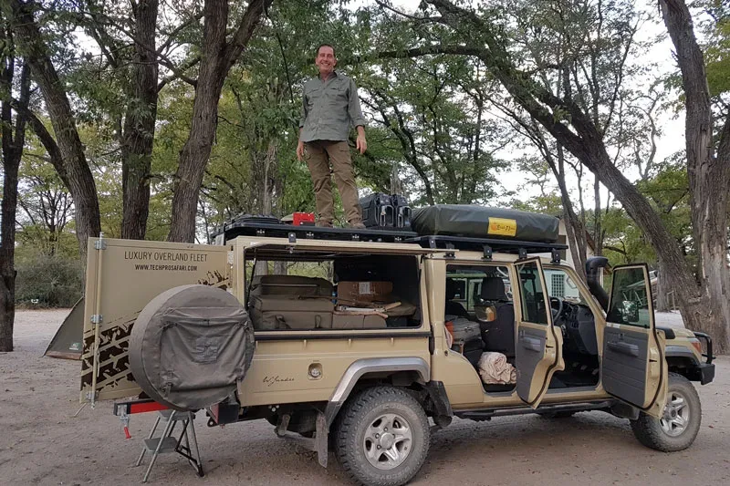 Land Cruiser set up for camp in mopane woodland