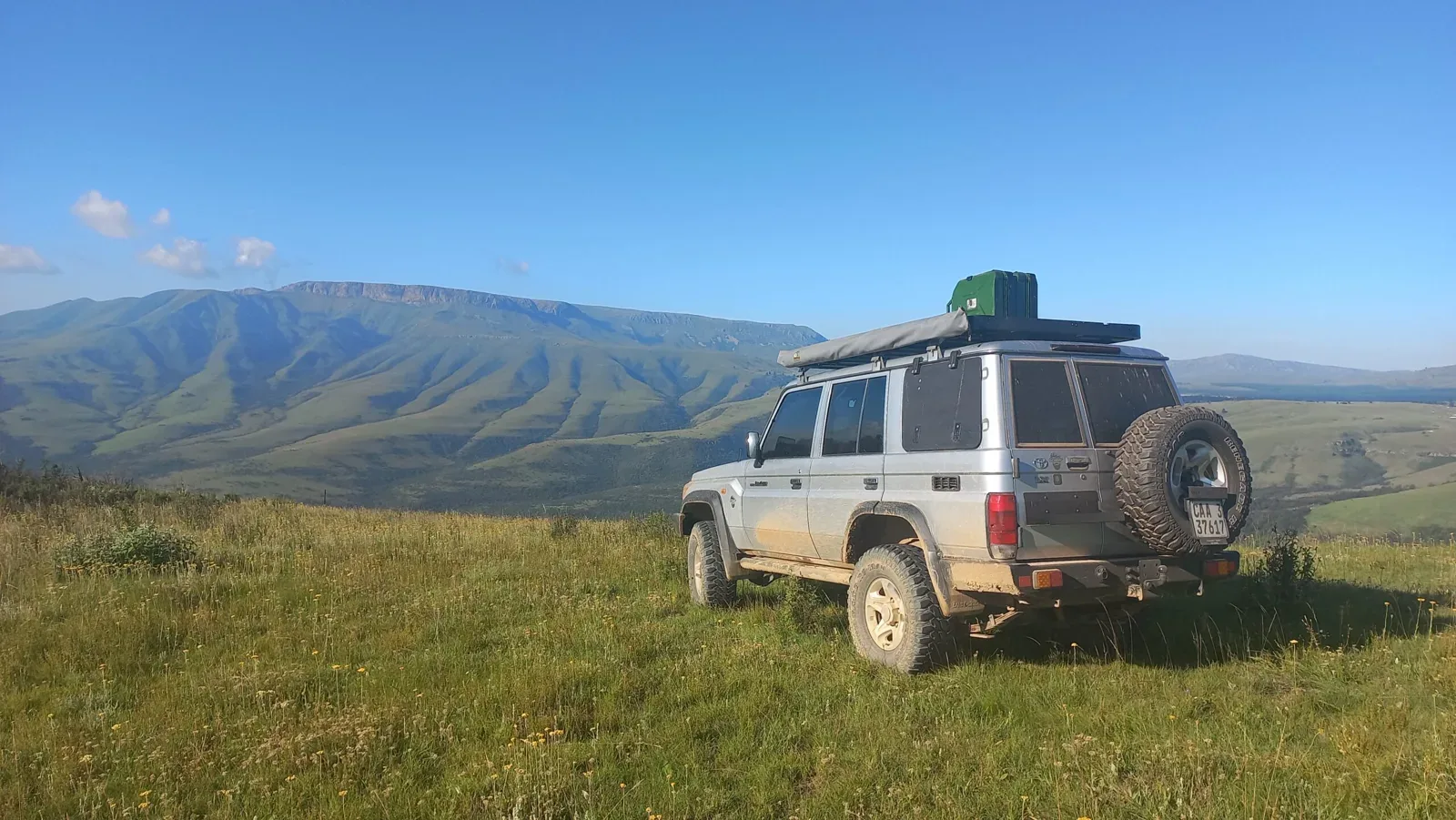 Land Cruiser station wagon parked on a green mountain plateau