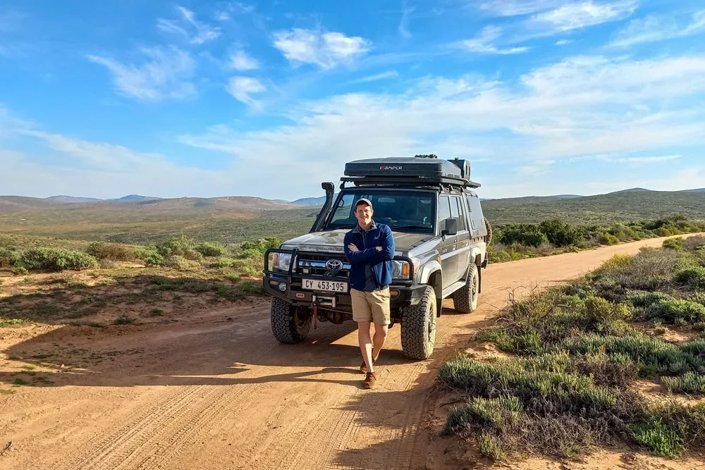 Mark Bland with a Land Cruiser 79 on a gravel road