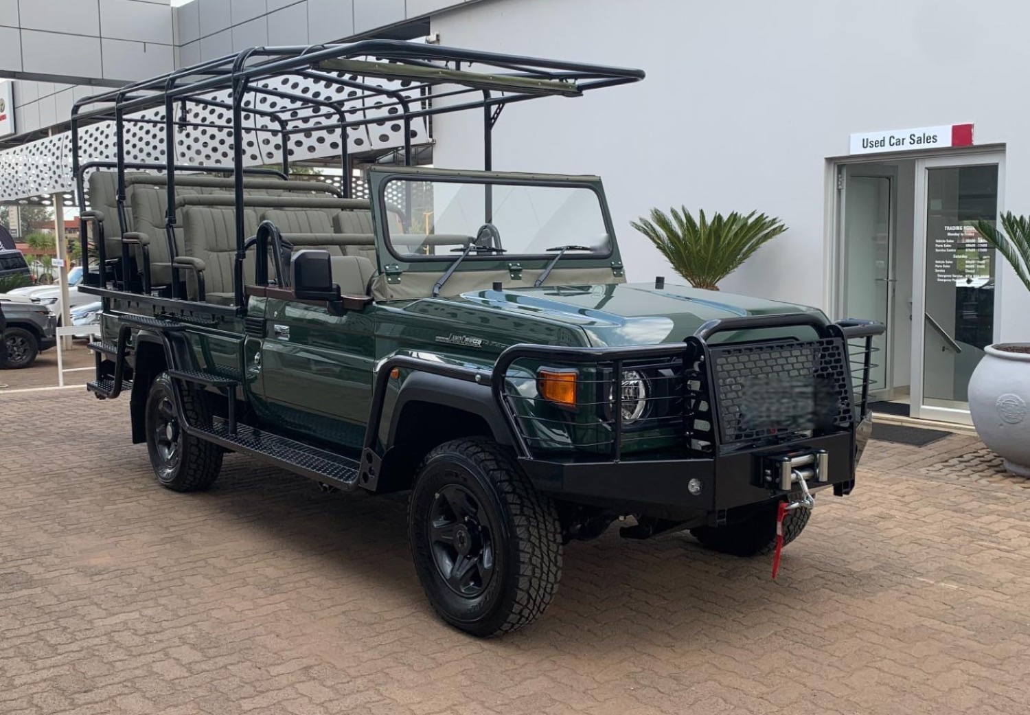 A Toyota Land Cruiser 79 game viewer — an open-sided safari vehicle with tiered bench seating — for sale in South Africa