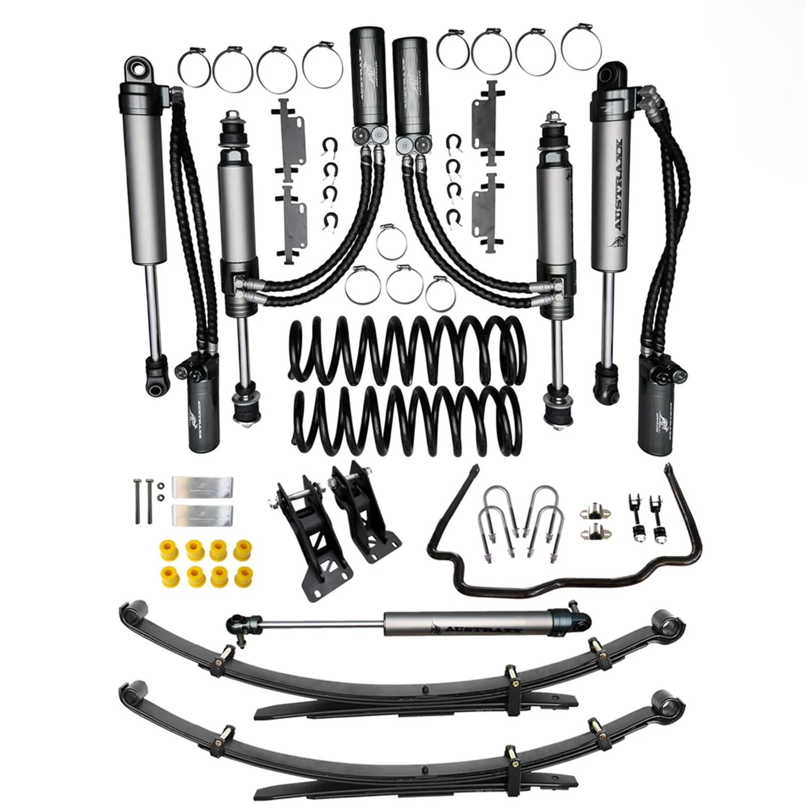 A full Austraxx suspension kit for the Land Cruiser 79 laid out on white: shocks with remote oil cans on hoses, coil springs, leaf springs and fitting parts