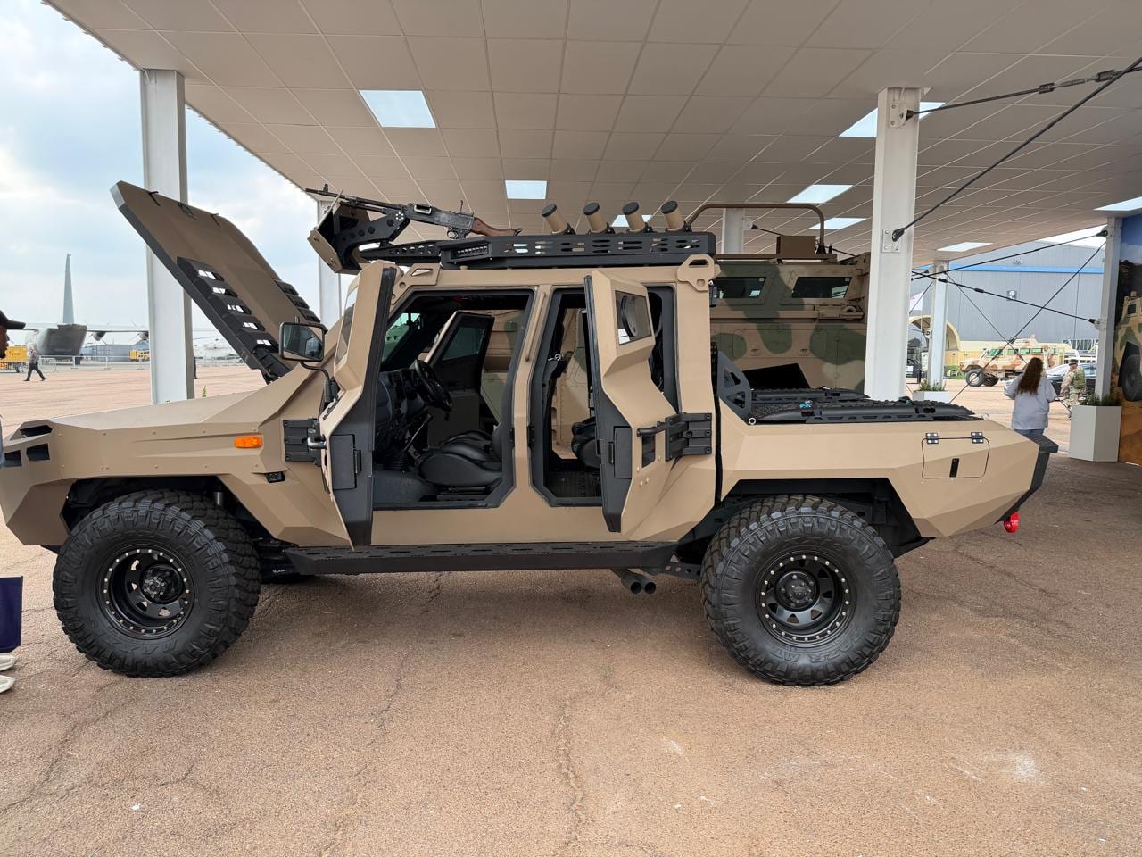 The Milkor Frontier side-on on Milkor's stand at AAD 2026, with all four doors and the bonnet open