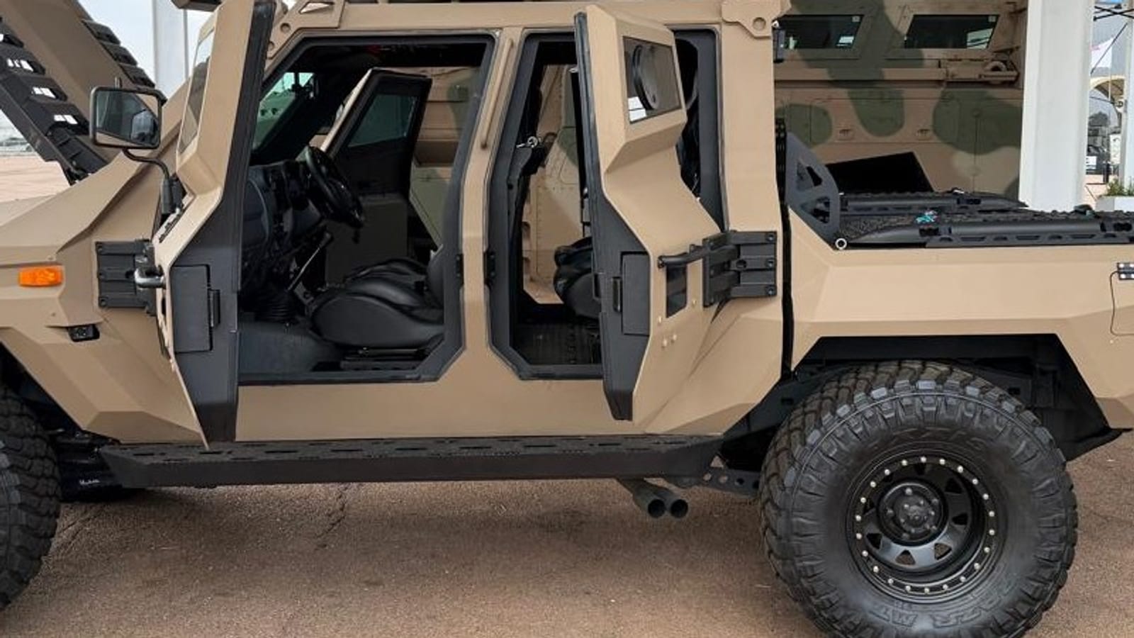 The Milkor Frontier's armoured doors open to show a Toyota Land Cruiser 79 steering wheel and seats, at AAD 2026